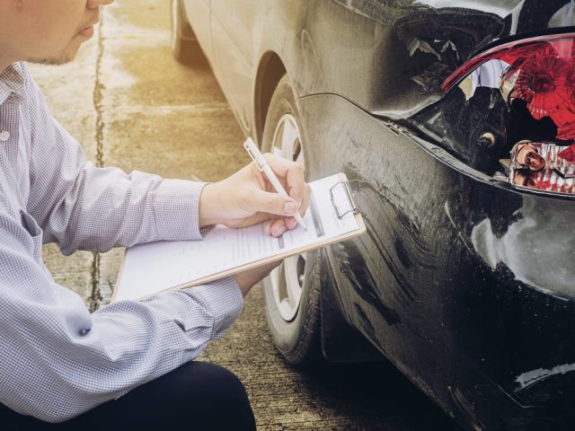 Insurance agent working on car accident claim process